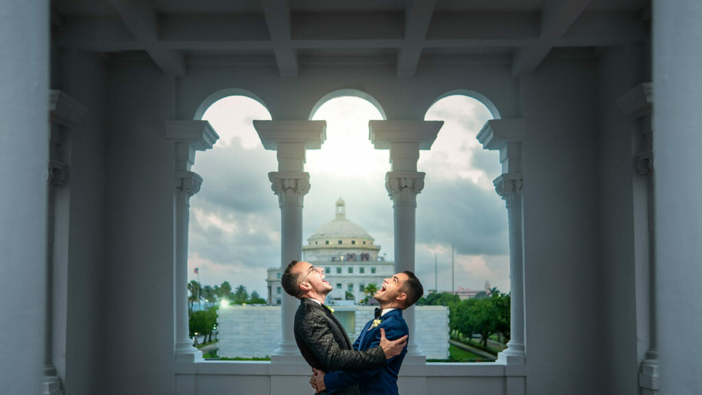 LGBT couple embracing in the romantic and historic setting of Casa España in San Juan, Puerto Rico.