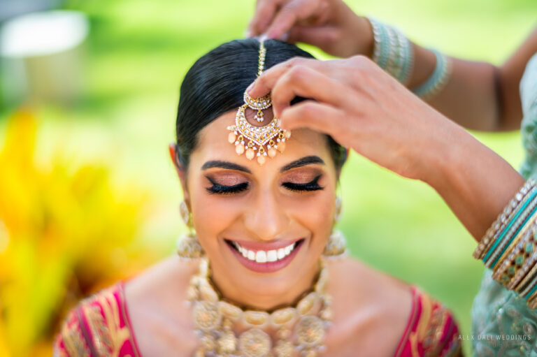 Indian bride getting her tikka put on during an Indian wedding celebration at Hyatt Grand Reserve in San Juan