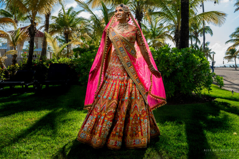 Indian bride in traditional wedding attire, wearing an ornate and colorful dress, adorned with intricate embroidery and jewelry, in San Juan, Puerto Rico.